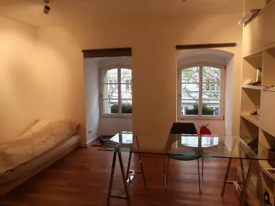 a living room with a glass table and two windows at Michal apartment 125m2 city centre in Prague