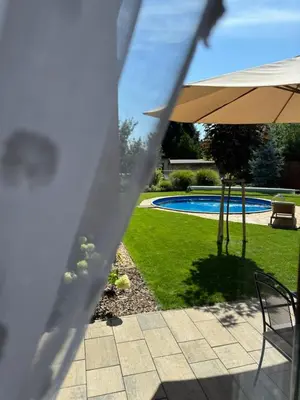 a view of a patio with an umbrella and a pool at Apartmán Květinová zahrada in Prague