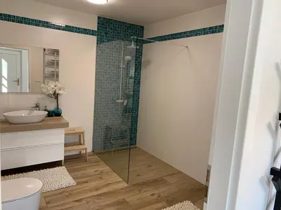 a bathroom with a shower and a sink at Apartmán Květinová zahrada in Prague