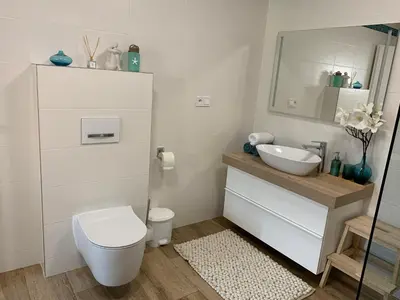 a white bathroom with a toilet and a sink at Apartmán Květinová zahrada in Prague