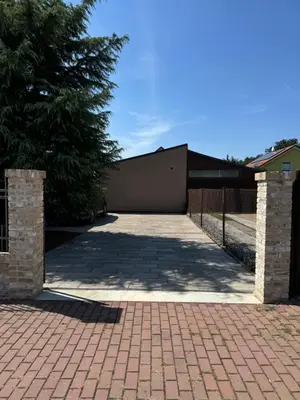 a parking lot with a gate and a driveway at Apartmán Květinová zahrada in Prague