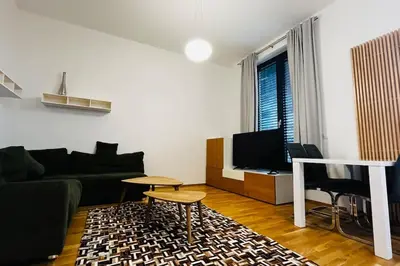 a living room with a couch and a tv at Apartment Holesovice, garden, garage in Prague