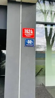 a sign on the side of a building at Apartment Holesovice, garden, garage in Prague