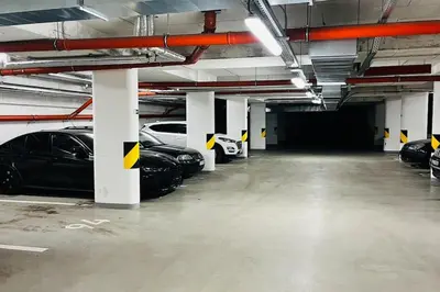 a large parking garage with cars parked in it at Apartment Holesovice, garden, garage in Prague