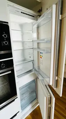 an empty refrigerator with its door open in a kitchen at Apartment Holesovice, garden, garage in Prague