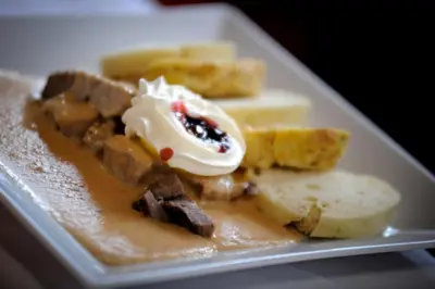 a plate of food with bread and ice cream at Hotel Ludmila in Mělník