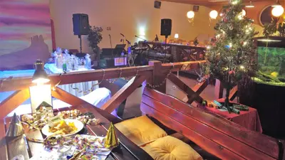 a dining room with a christmas tree and a table at Hotel Ludmila in Mělník