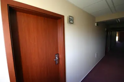 a wooden door leading into a hallway with a hallway at Hotel Ludmila in Mělník