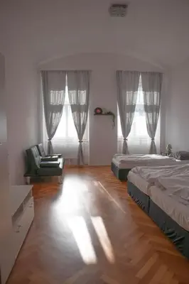 a bedroom with two beds and a chair in it at Modern Apartment in the Center of Prague in Prague