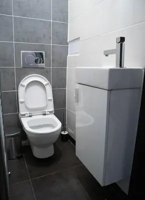 a bathroom with a white toilet and a sink at Modern Apartment in the Center of Prague in Prague