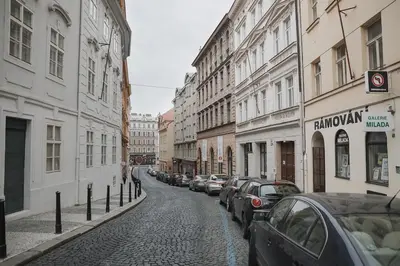 a cobblestone street with cars parked on the side at Skolska Junior apartment in Prague