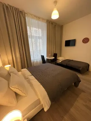 a bedroom with a large bed and a window at Maria Apartment Liben in Prague