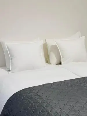 a large white bed with white pillows on it at Maria Apartment Liben in Prague