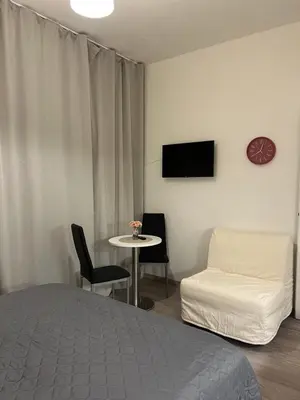 a bedroom with a bed and a table and a couch at Maria Apartment Liben in Prague