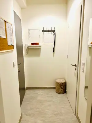a hallway with a door and a stool in a room at Maria Apartment Liben in Prague