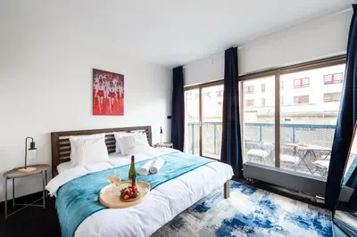 a living room with a couch and a kitchen at Spacious apartments near Karlín Square in Prague