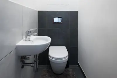 a bedroom with a bed and a yellow chair at Spacious apartments near Karlín Square in Prague