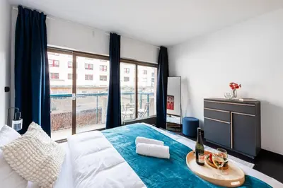 a bedroom with a bed and a desk with a computer at Spacious apartments near Karlín Square in Prague