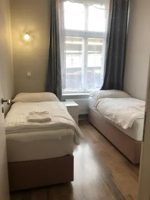 a bedroom with two beds and a window at Cozy Homestay at Prague Main Station in Prague