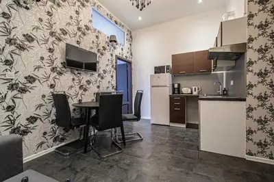 a kitchen with a table and chairs in a room at Cozy Homestay at Prague Main Station in Prague