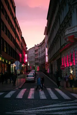 a group of people crossing a street in a city at Cozy Homestay at Prague Main Station in Prague