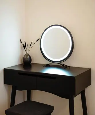 a mirror sitting on top of a black desk at Tran Chien Apartment with free private parking in Prague