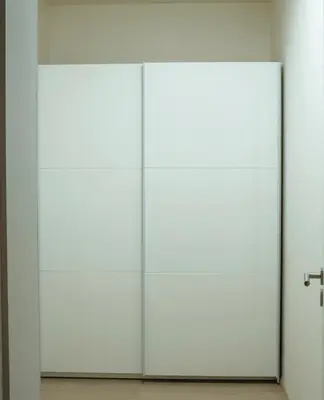 a pair of white doors in a room at Tran Chien Apartment with free private parking in Prague