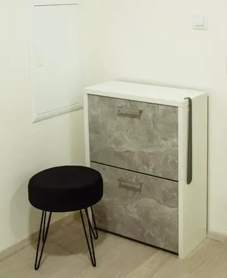 a black stool next to a dresser and a drawer at Tran Chien Apartment with free private parking in Prague