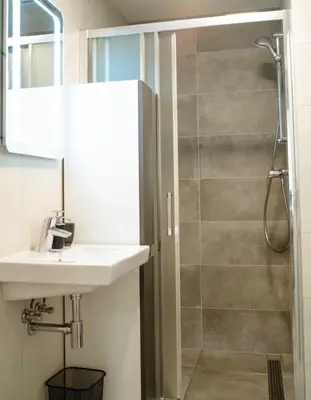 a bathroom with a sink and a shower at Tran Chien Apartment with free private parking in Prague