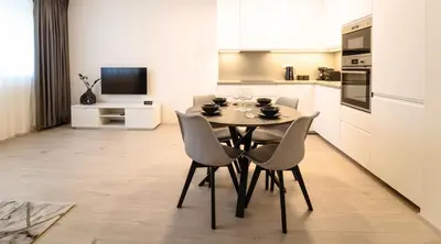 a dining room with a table and chairs in a kitchen at Tran Chien Apartment with free private parking in Prague