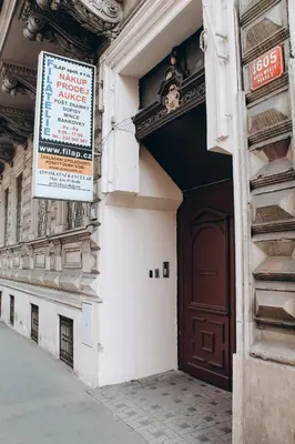 a building with a door and a sign on it at Sokolska in Prague