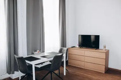 a living room with a table and a tv on a dresser at Sokolska in Prague