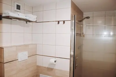 a shower with a glass door in a bathroom at Sokolska in Prague