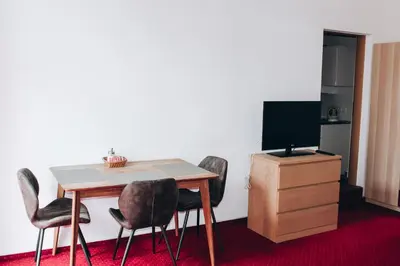 a room with a table and chairs and a television at Sokolska in Prague