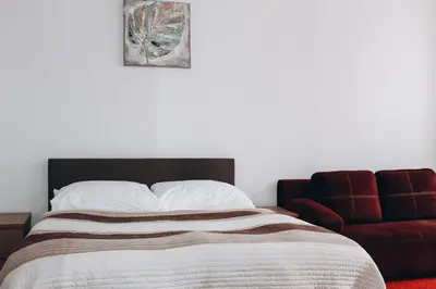 a bedroom with a bed and a red couch at Sokolska in Prague