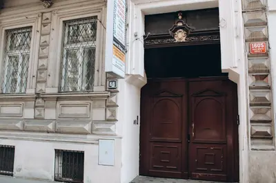 a building with a brown door and two windows at Sokolska in Prague