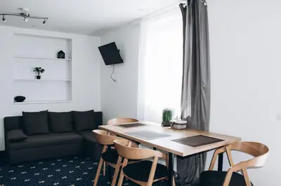 a living room with a table and chairs and a couch at Sokolska in Prague