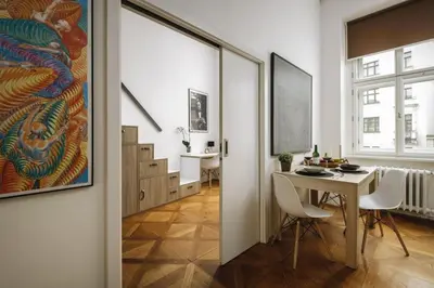 a living room with a table and a dining room at Cozy & comfortable apt walking anywhere you want SEN in Prague