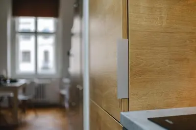 a wooden door in a room with a table at Cozy & comfortable apt walking anywhere you want SEN in Prague