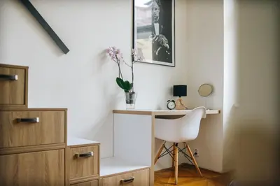 a room with a desk and a white chair at Cozy & comfortable apt walking anywhere you want SEN in Prague