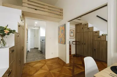 a room with a hallway with a table and a mirror at Cozy & comfortable apt walking anywhere you want SEN in Prague