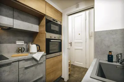 a kitchen with a sink and a stove top oven at Cozy & comfortable apt walking anywhere you want SEN in Prague