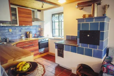 a kitchen with a bowl of bananas on a table at Chalupa Ořešák - Walnut House in Svojšice