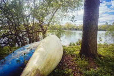 a blue and white boat sitting next to a tree at Chalupa Ořešák - Walnut House in Svojšice