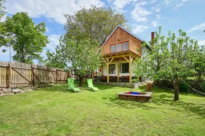 a yard with a house with a fence and a house at Chalupa Ořešák - Walnut House in Svojšice