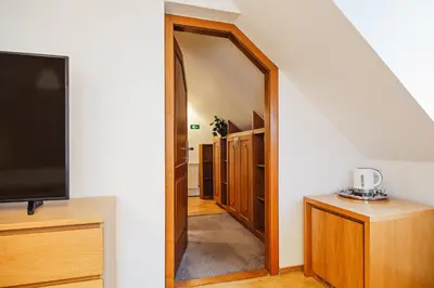 a hallway with a door leading into a room with a tv at U modrého orla - At the blue eagle in Prague