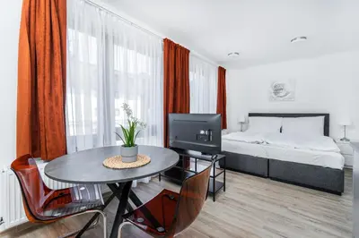 a bedroom with a bed and a table with a television at Apartmán v Poděbradech in Poděbrady
