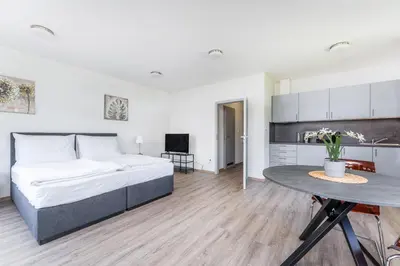 a bedroom with a large bed and a table at Apartmán v Poděbradech in Poděbrady