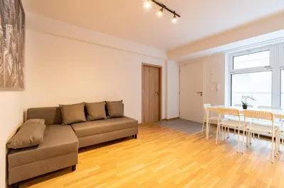 a living room with a couch and a table at Brand new two room apartment #26 with free secure parking close to center in Prague