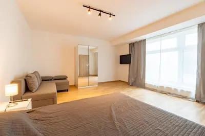 a living room with a bed and a couch at Brand new two room apartment #26 with free secure parking close to center in Prague